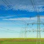 gray electric post under white and blue cloudy sky